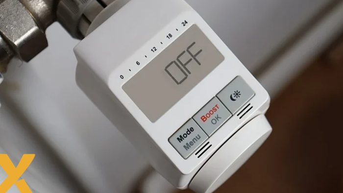 Digitale thermostaatknop met 'OFF'-stand op een verwarmingsradiator.