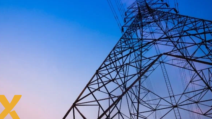 Hoogspanningsmast tegen een kleurrijke avondlucht, symbool voor elektriciteitsvoorziening en energienetwerk.