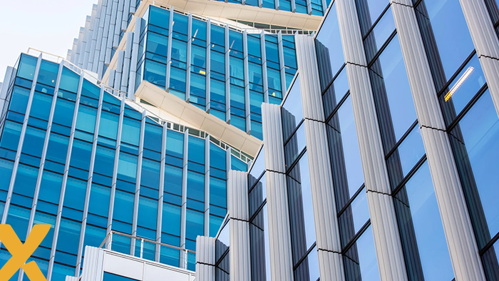 Moderne kantoorgebouwen met blauwe ramen en opvallende architectonische lijnen.